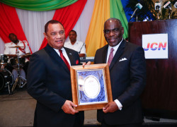 The Rt. Hon Perry Christie, Prime Minister accepts The Person of the Year Award for 2015 from CEO of Jones Communications, Wendall Jones