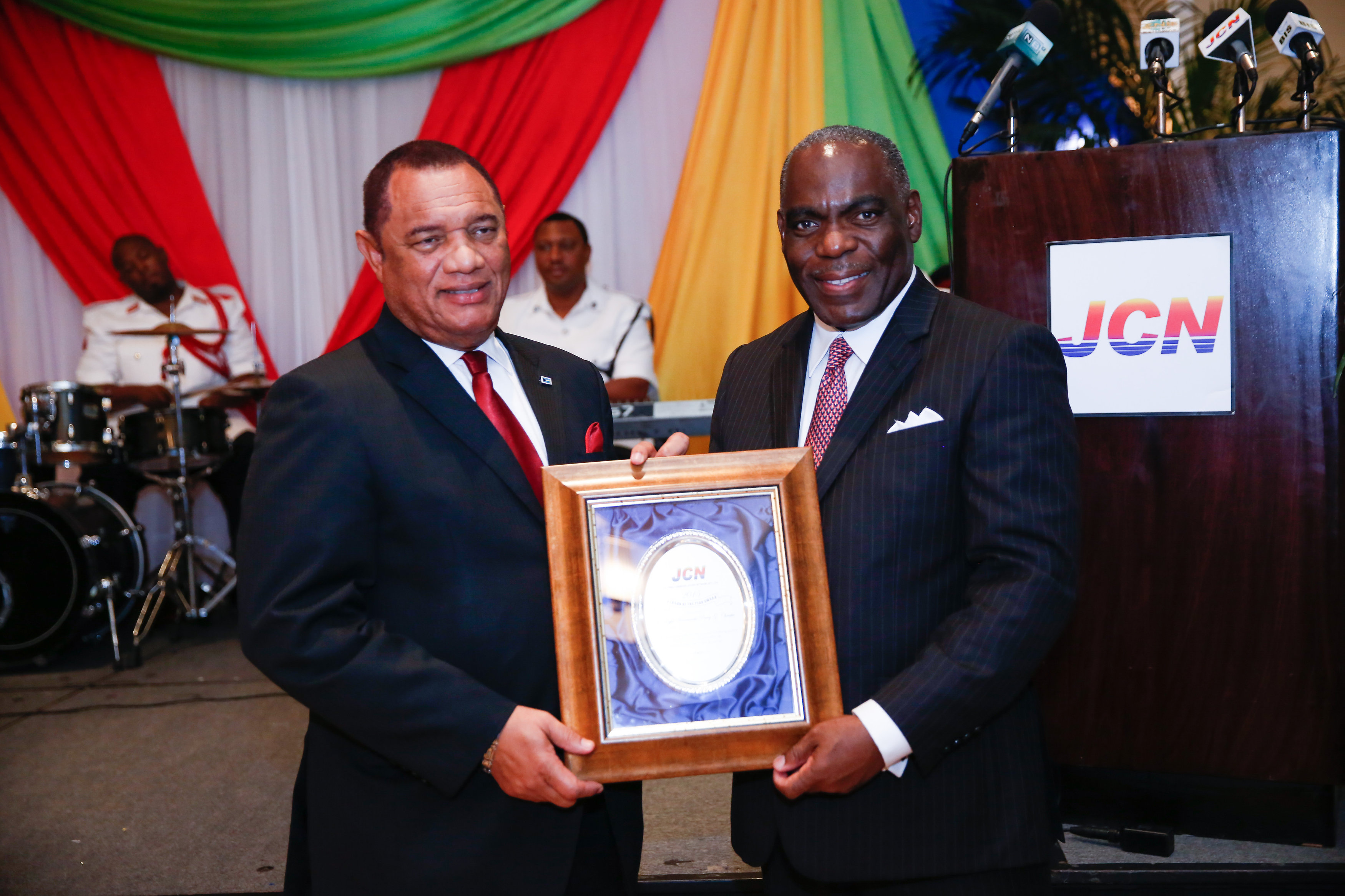 The Rt. Hon Perry Christie, Prime Minister accepts The Person of the Year Award for 2015 from CEO of Jones Communications, Wendall Jones